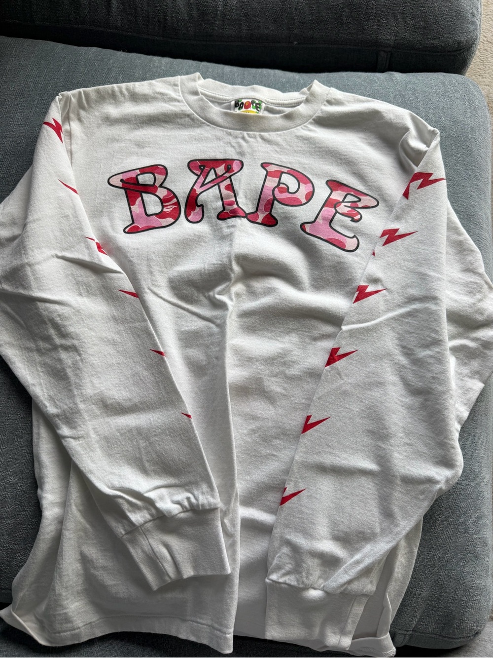 Bape White Long Sleeve Tee with Pink Camo Logo and Red Bolt Accents